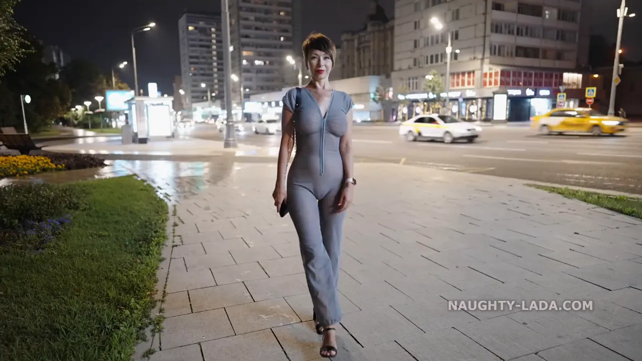 Brunette MILF in a transparent fetish suit walks alone