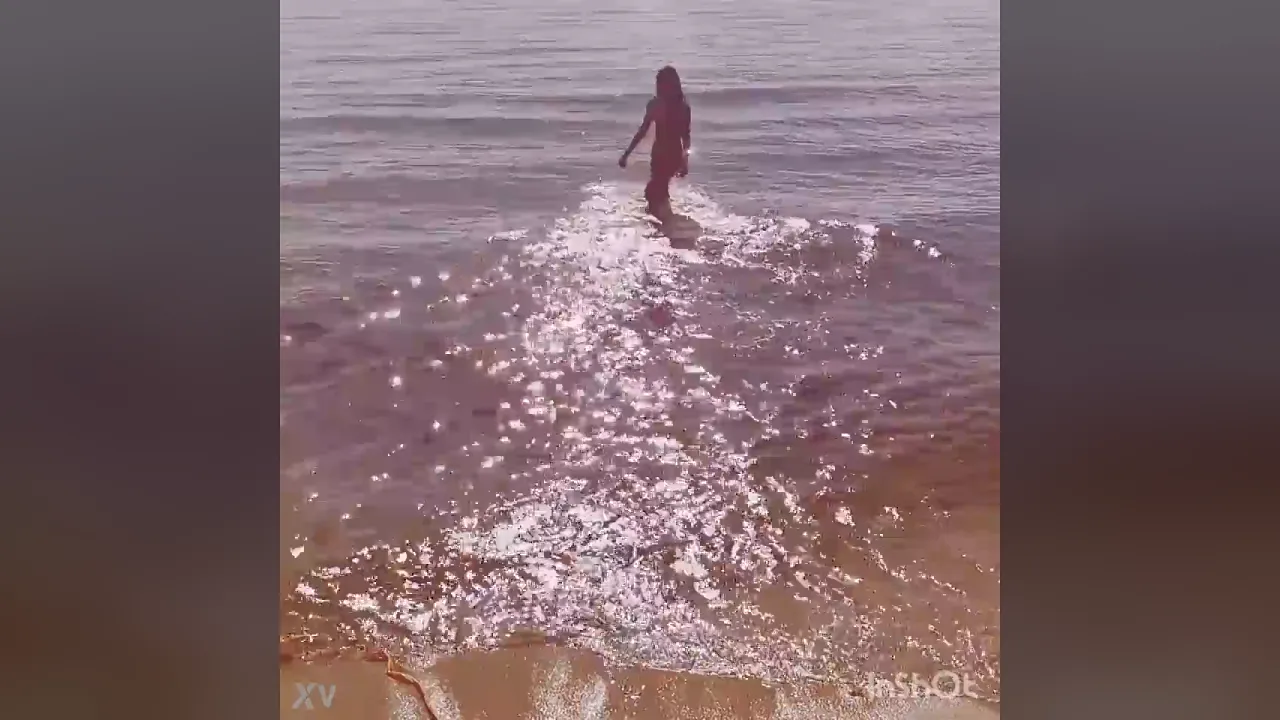 Beautiful Monica plays and splashes at the beach