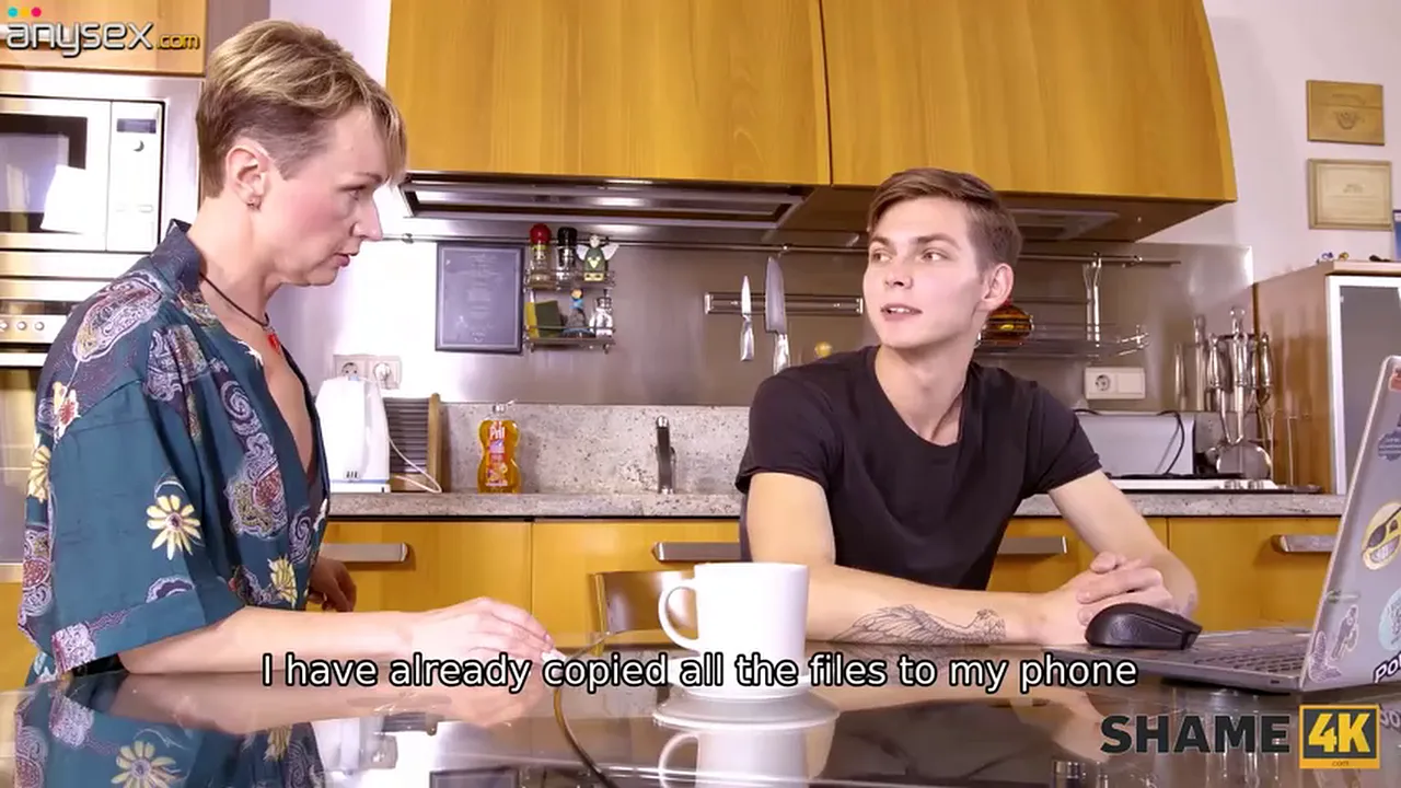 Mature blonde MILF rides young cock in kitchen