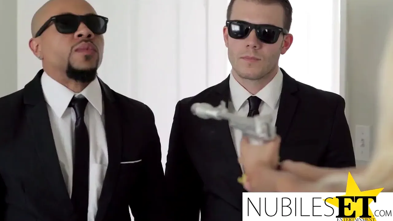 Blonde babe performs a double blowjob before having a threesome with two Men in Black