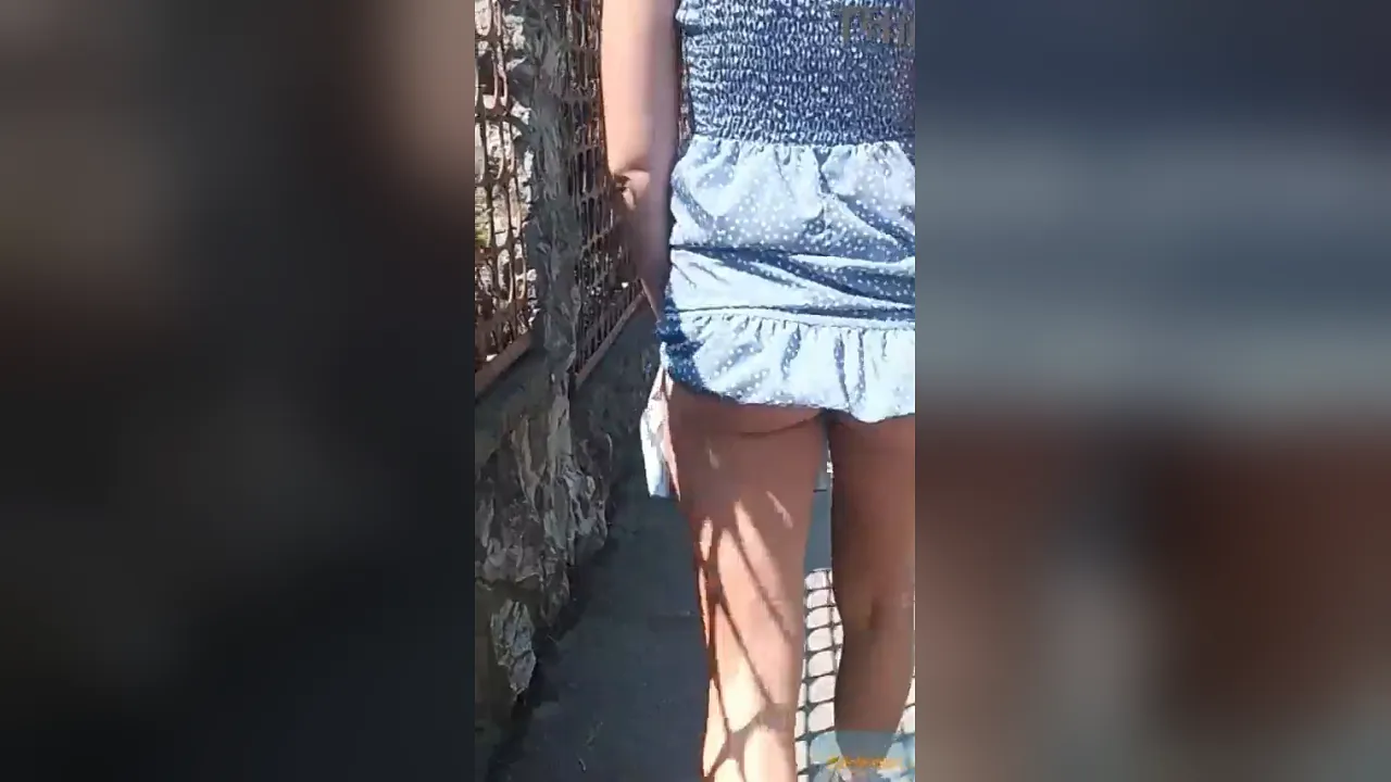 MILF flashes her perfect ass while walking down the street