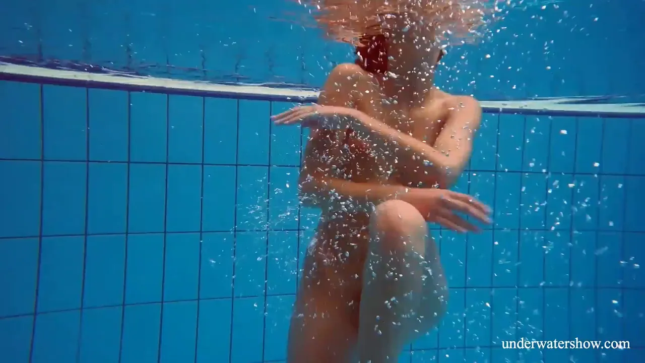 Marusia the hottest petite Russian brunette shows off her hairy pussy underwater by the