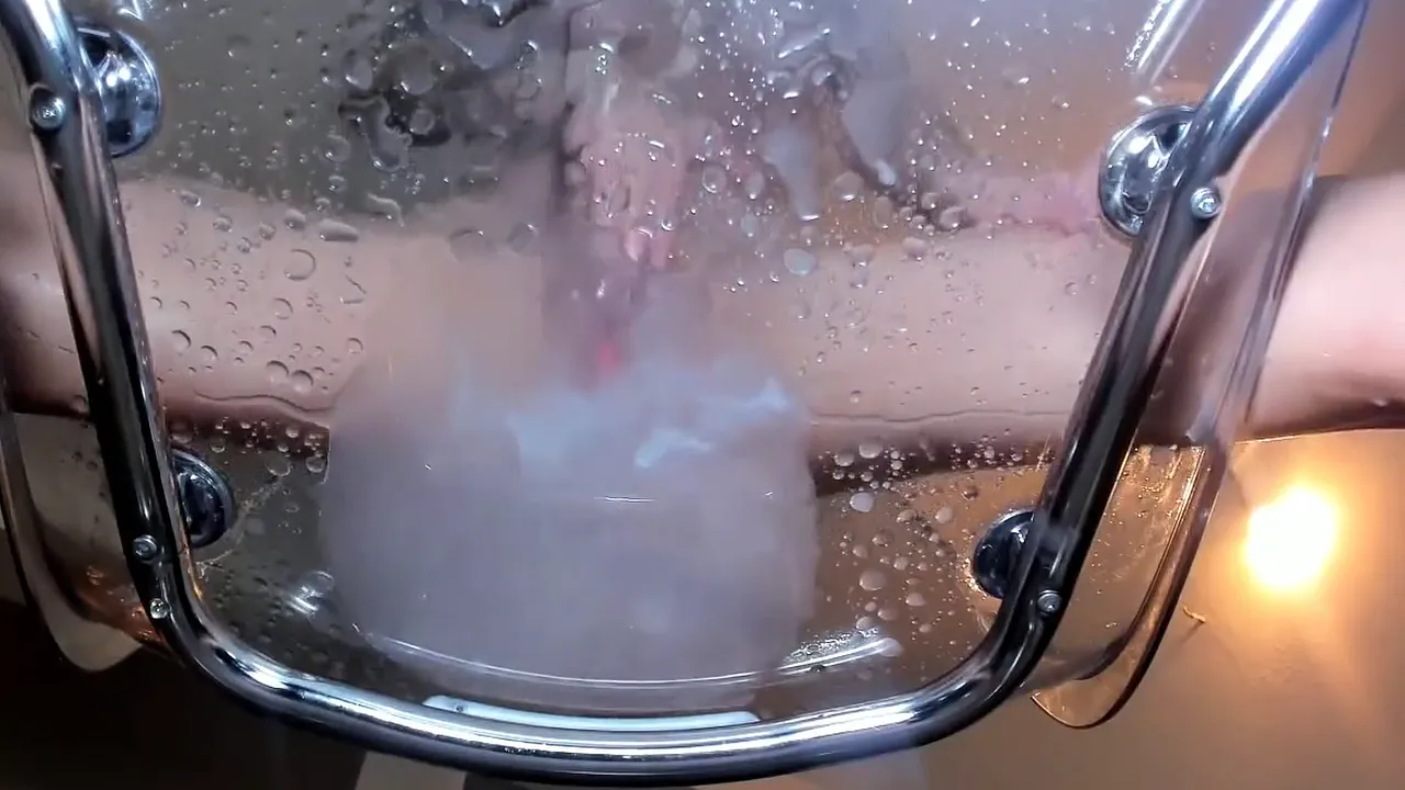 Busty brunette squirts all over the transparent chair while using a sex toy