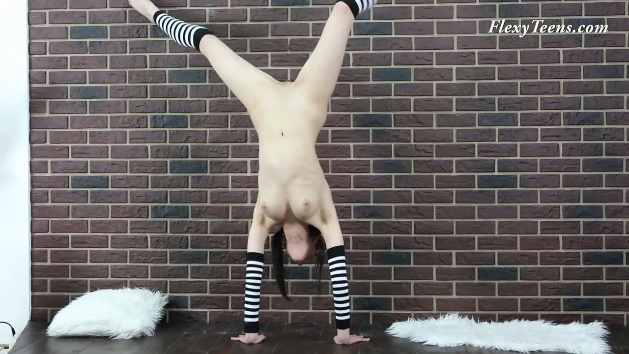 Flexible girl poses seductively in stockings