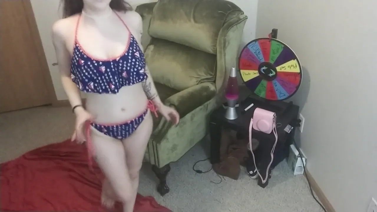Redhead stripper with braces shows off her big ass and small tits in bikinis