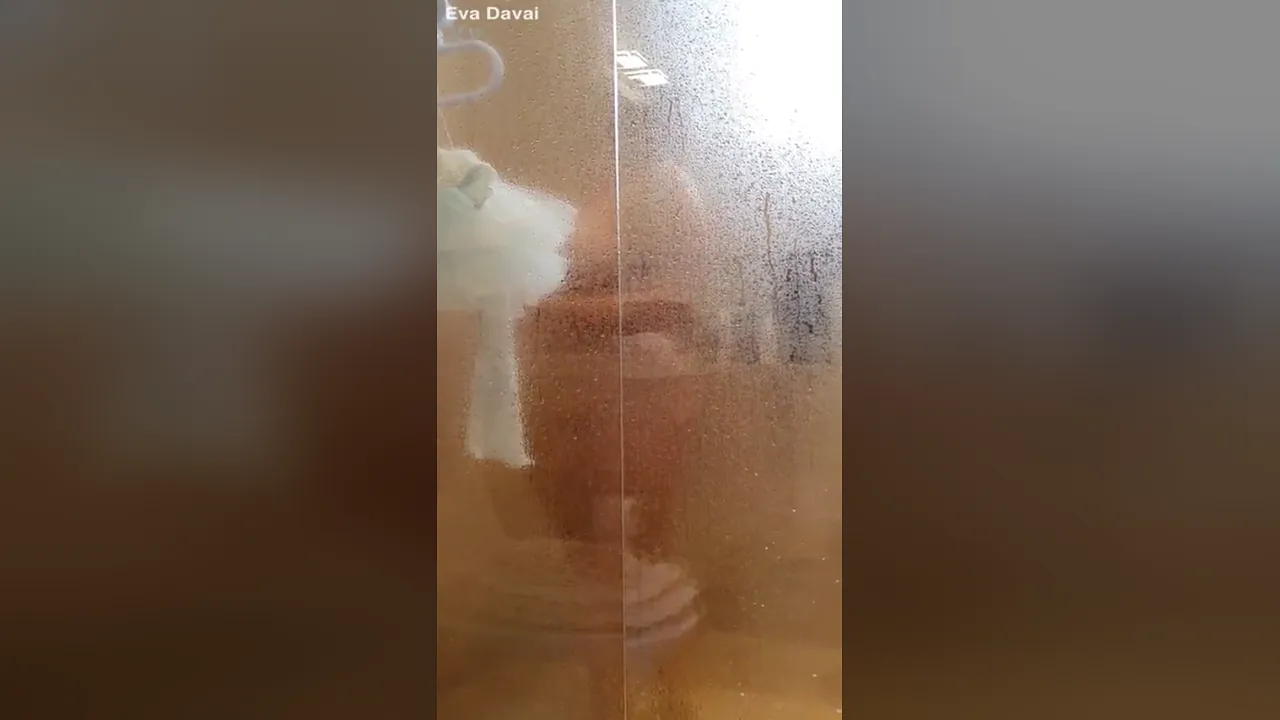 Blonde MILF Eva Davai masturbates with big dildo in solo shower scene
